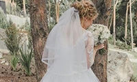 A bride in white stands outdoors with a bouquet amid greenery, featuring STEP 4: Additional Items.